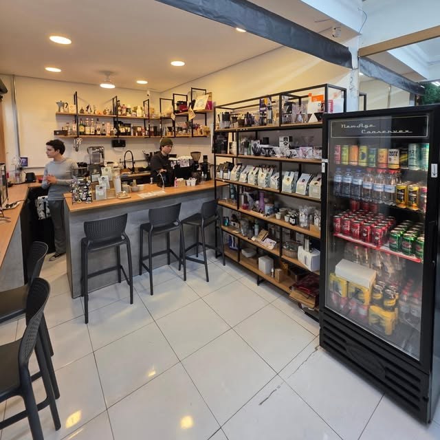 The bar counter and retail shelving at Kento Café Roastery